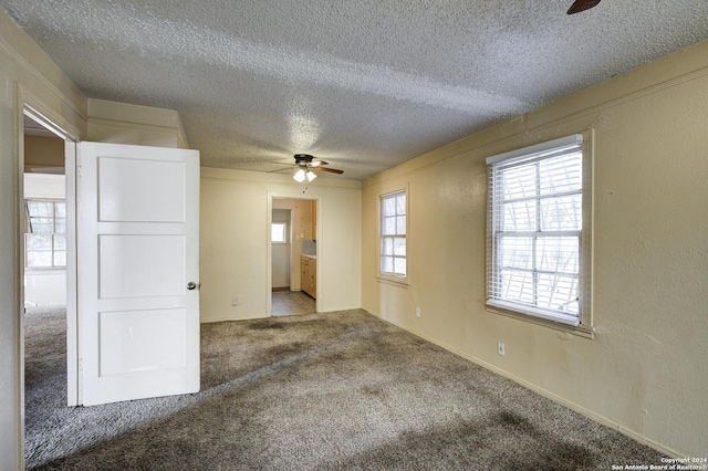 spare room with ceiling fan, carpet floors, and a textured ceiling