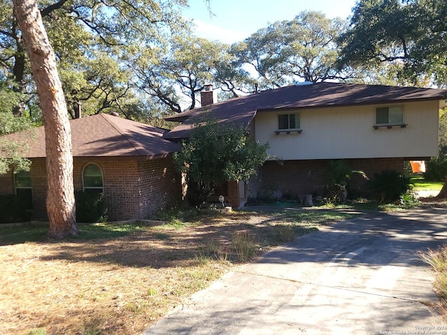 view of home's exterior with brick siding and a chimney