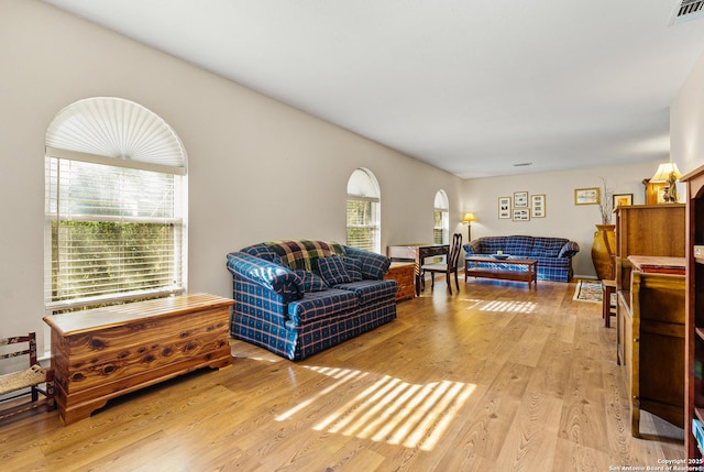 living room with visible vents and light wood-style flooring