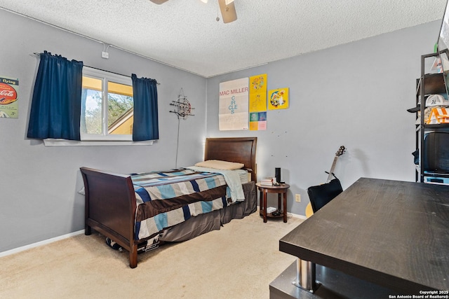 carpeted bedroom featuring ceiling fan, a textured ceiling, and baseboards