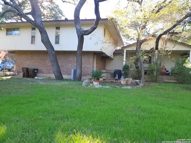 rear view of property featuring a lawn