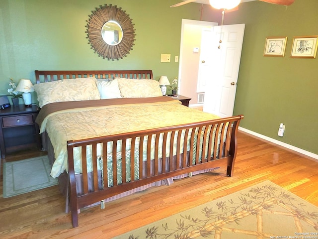 bedroom with hardwood / wood-style flooring and ceiling fan