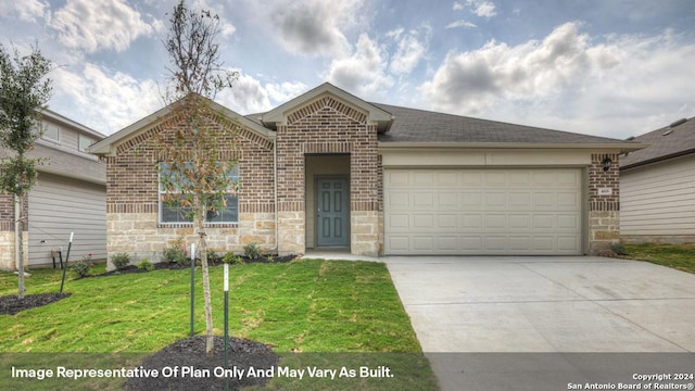 view of front of property featuring a front yard and a garage