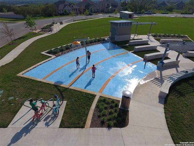 view of swimming pool featuring a lawn