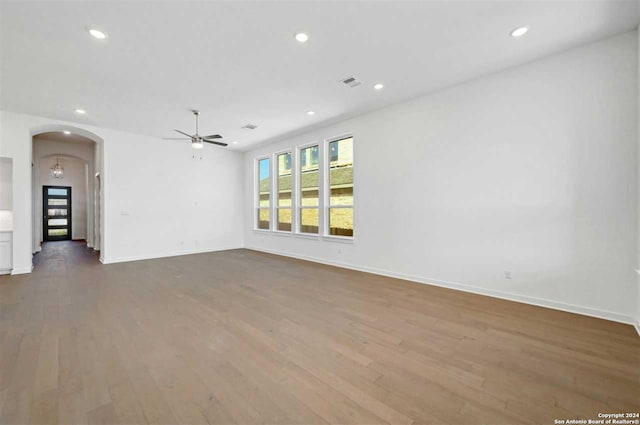 unfurnished living room featuring hardwood / wood-style flooring and ceiling fan