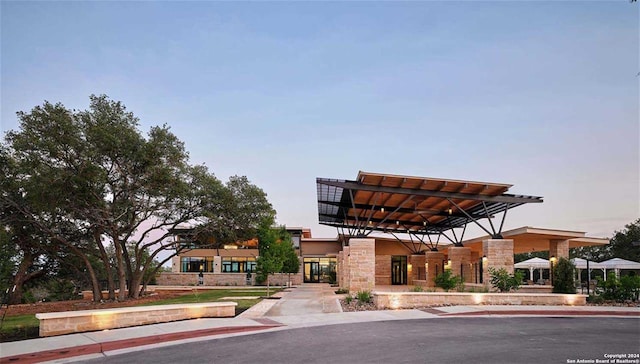 view of outdoor building at dusk