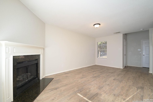 unfurnished living room featuring hardwood / wood-style flooring