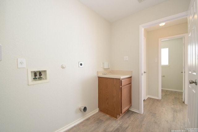 laundry area with washer hookup, electric dryer hookup, light hardwood / wood-style floors, and gas dryer hookup