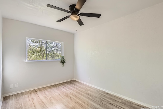 spare room featuring light hardwood / wood-style floors and ceiling fan