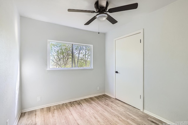 empty room featuring ceiling fan and light hardwood / wood-style flooring