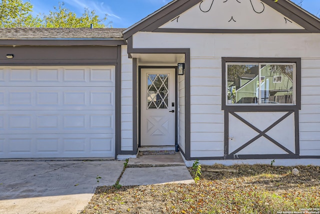 view of exterior entry with a garage