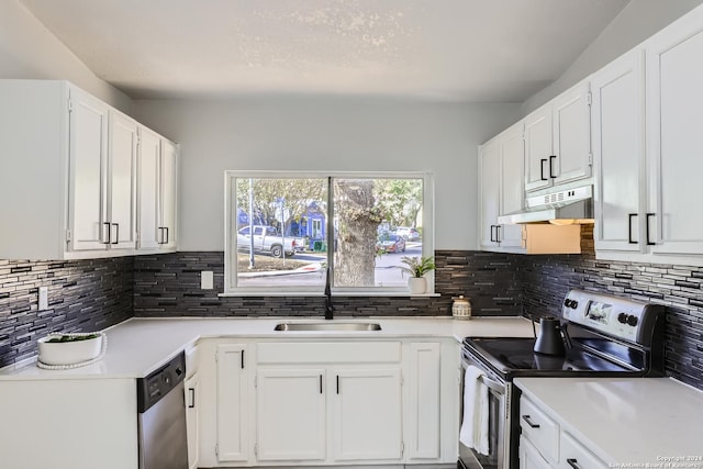 kitchen featuring sink, white cabinetry, stainless steel appliances, and tasteful backsplash