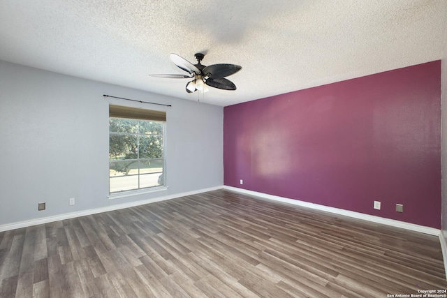 unfurnished room featuring ceiling fan, dark hardwood / wood-style flooring, and a textured ceiling