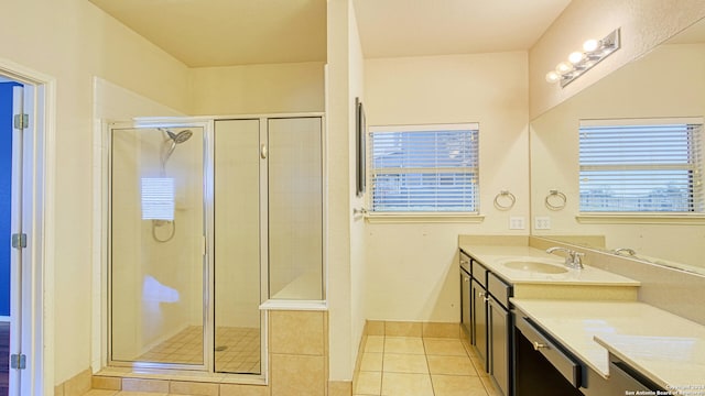 bathroom with tile patterned flooring, vanity, and a shower with door