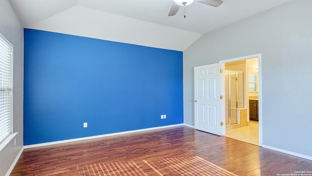 empty room with hardwood / wood-style flooring, ceiling fan, and lofted ceiling