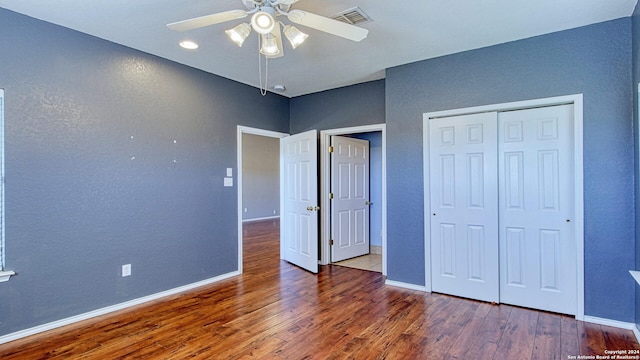 unfurnished bedroom with ceiling fan, a closet, and wood-type flooring