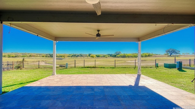 view of patio / terrace featuring ceiling fan and a rural view