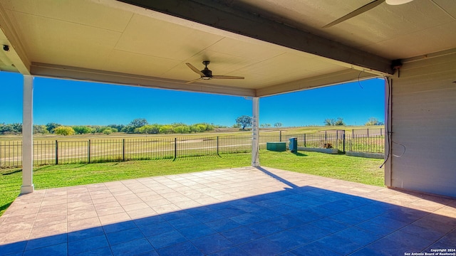 view of patio / terrace with ceiling fan and a rural view