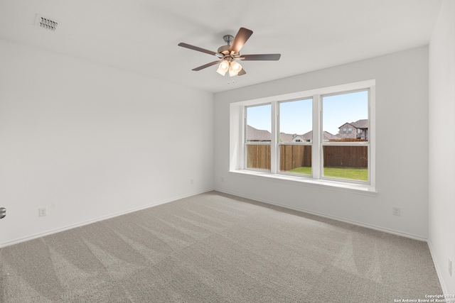 carpeted empty room featuring ceiling fan