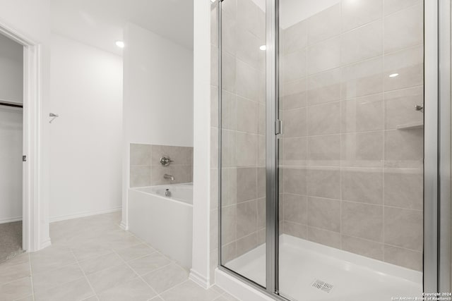 bathroom featuring plus walk in shower and tile patterned floors