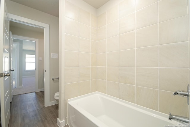 bathroom featuring hardwood / wood-style flooring and toilet