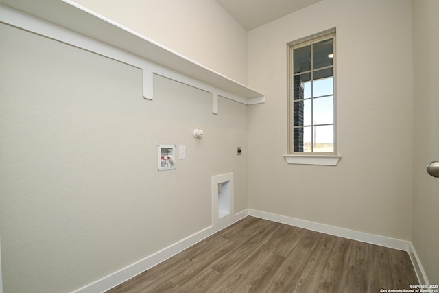 clothes washing area featuring electric dryer hookup, hookup for a washing machine, dark hardwood / wood-style flooring, and gas dryer hookup