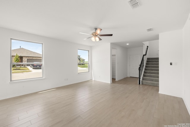 unfurnished room featuring ceiling fan and light wood-type flooring