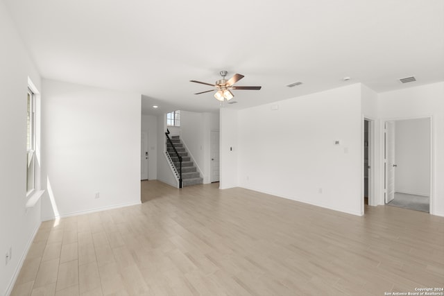 spare room featuring ceiling fan and light hardwood / wood-style flooring