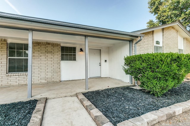 doorway to property featuring covered porch