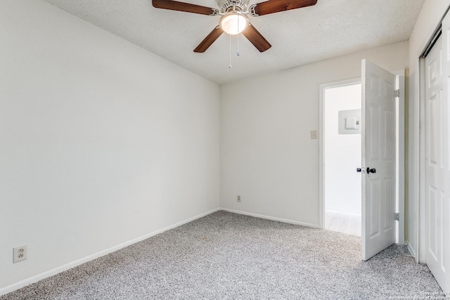 carpeted empty room with a textured ceiling and ceiling fan