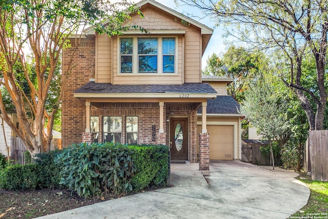 view of front of home featuring a porch and a garage