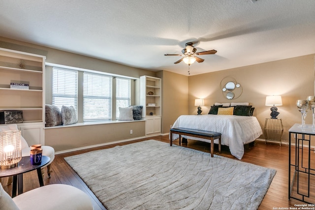 bedroom featuring a textured ceiling, dark hardwood / wood-style flooring, and ceiling fan