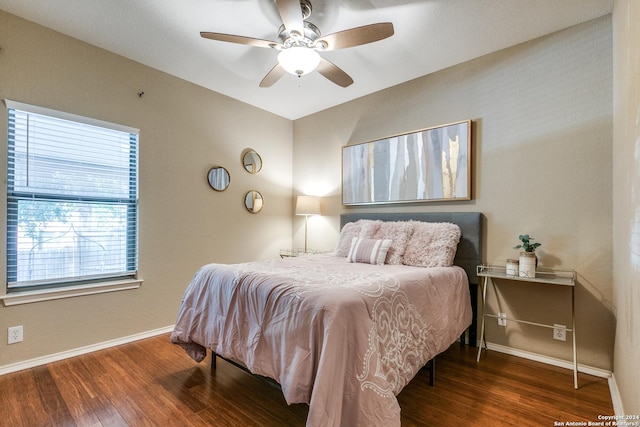 bedroom with ceiling fan and dark wood-type flooring