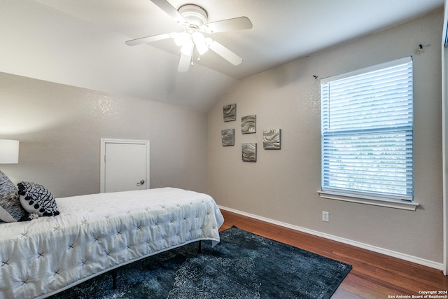 bedroom with ceiling fan, dark hardwood / wood-style flooring, and lofted ceiling