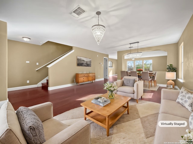 carpeted living room featuring a chandelier