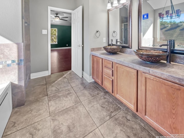 bathroom featuring tile patterned floors, ceiling fan with notable chandelier, and vanity