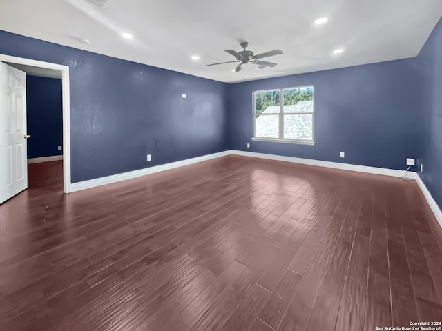 spare room featuring dark hardwood / wood-style flooring and ceiling fan