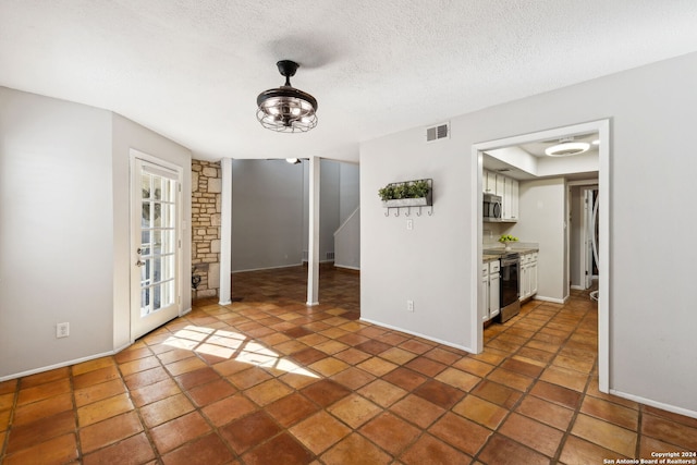 unfurnished room featuring a textured ceiling