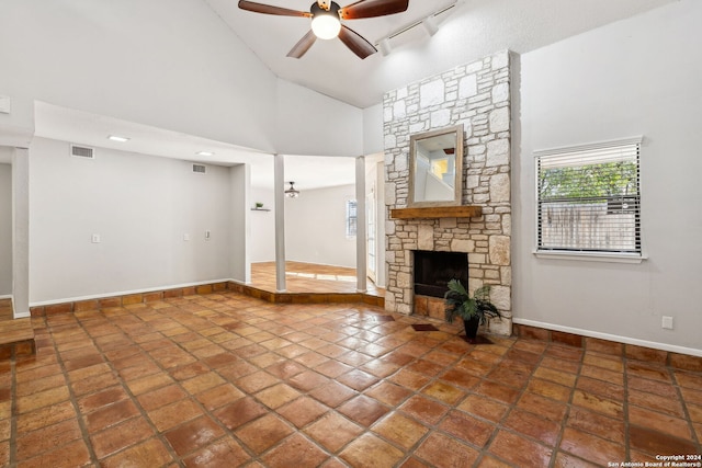 unfurnished living room featuring a fireplace, high vaulted ceiling, and ceiling fan