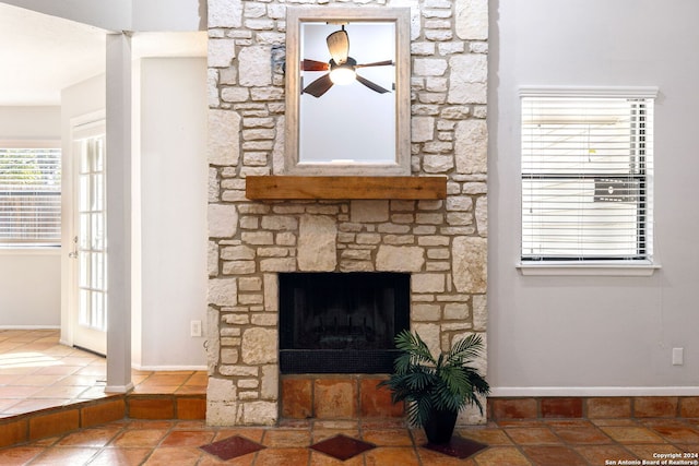 details featuring a fireplace and ceiling fan