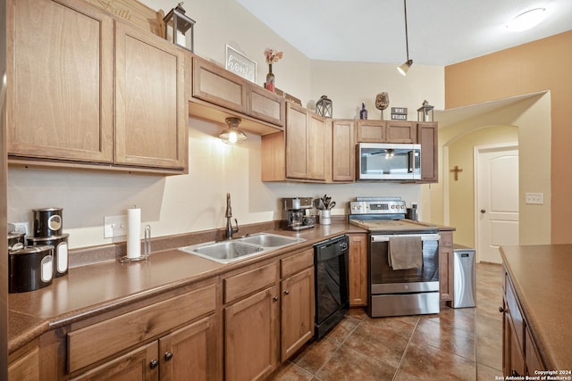 kitchen featuring sink, dark tile patterned floors, and stainless steel appliances