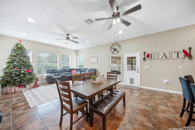 tiled dining space featuring ceiling fan and plenty of natural light