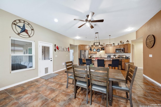 tiled dining area featuring ceiling fan