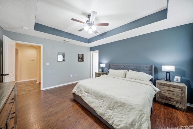 bedroom with dark hardwood / wood-style floors and ceiling fan