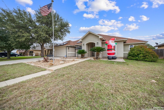 ranch-style home with a front yard and a garage