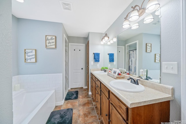 bathroom featuring a bathing tub, tile patterned flooring, and vanity