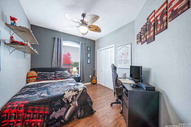 bedroom with wood-type flooring, a closet, and ceiling fan