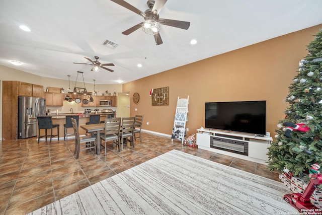 living room featuring ceiling fan and sink