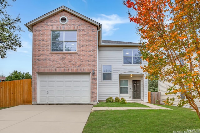 view of property with a front yard and a garage