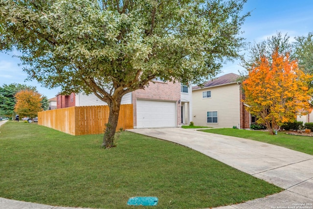 view of front facade with a front yard and a garage